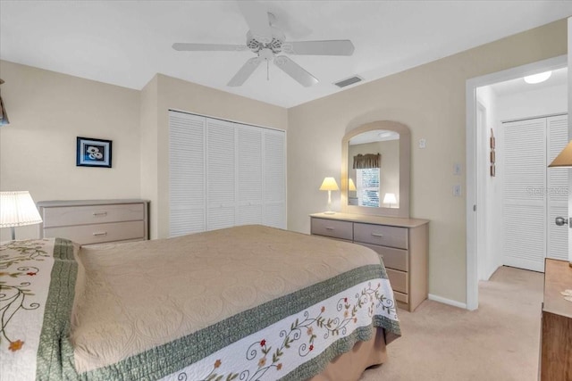 carpeted bedroom with ceiling fan and a closet