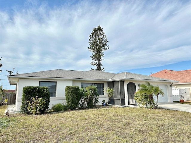 ranch-style home with a front lawn and a garage