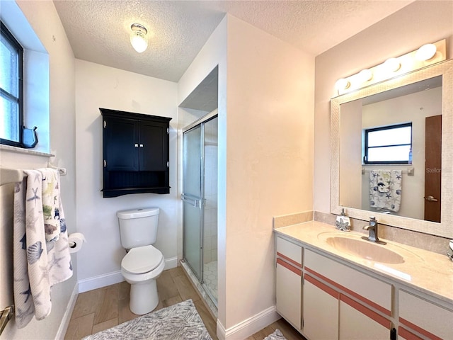 bathroom featuring toilet, vanity, a shower with door, and hardwood / wood-style floors