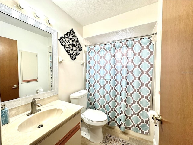 bathroom featuring toilet, vanity, a textured ceiling, and curtained shower