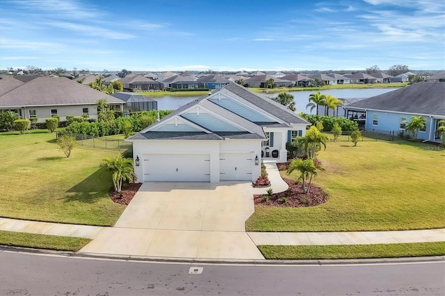 view of front of house with a water view, a front yard, and a garage