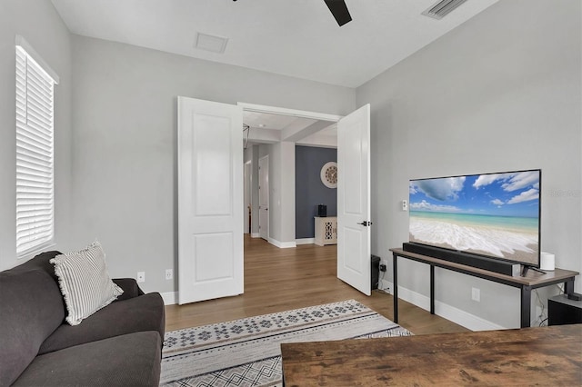 living room with ceiling fan and hardwood / wood-style floors