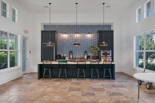 bar with double oven, paneled built in refrigerator, and pendant lighting