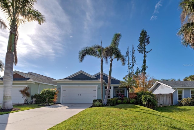 ranch-style home with a garage and a front lawn