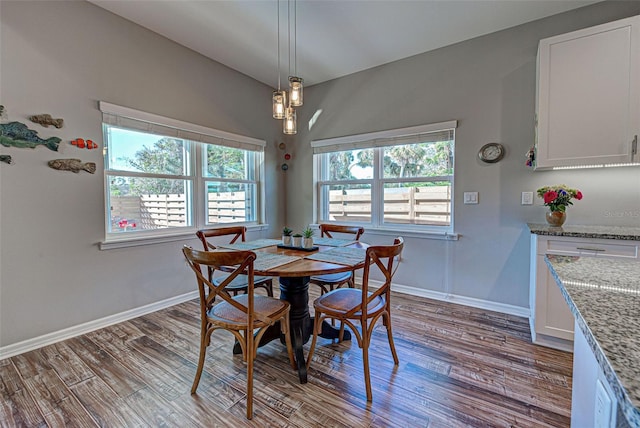 dining area featuring vaulted ceiling and light hardwood / wood-style floors