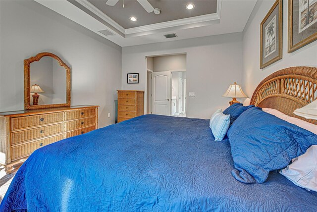 bedroom with crown molding, ceiling fan, and a tray ceiling