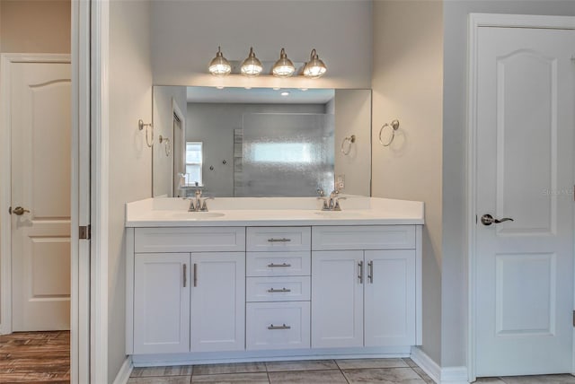 bathroom with vanity and a shower