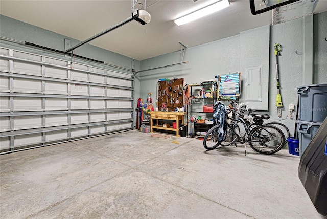 garage with a garage door opener and electric panel