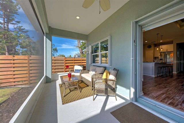 exterior space with an outdoor living space and ceiling fan