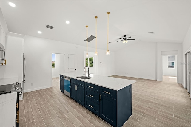 kitchen with a kitchen island with sink, appliances with stainless steel finishes, blue cabinetry, sink, and decorative light fixtures