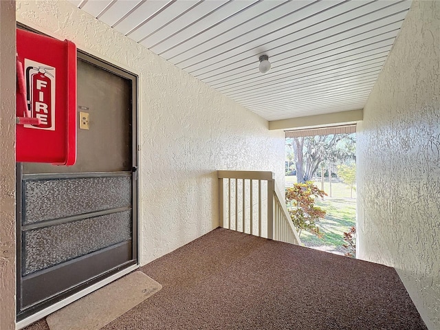 doorway to property featuring a balcony and stucco siding