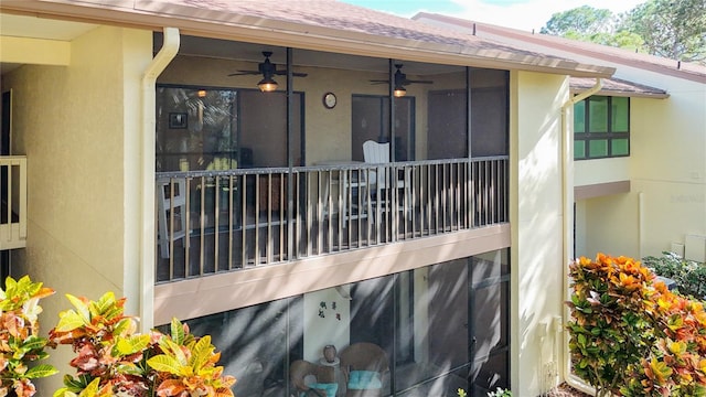 exterior space with ceiling fan, roof with shingles, and stucco siding