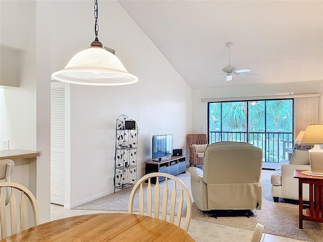 living room featuring a ceiling fan, lofted ceiling, light carpet, and baseboards