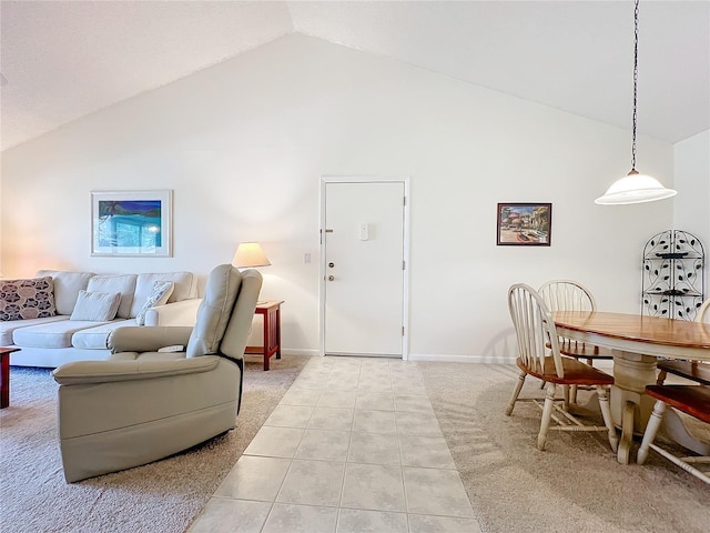 living room featuring high vaulted ceiling, baseboards, and light tile patterned floors