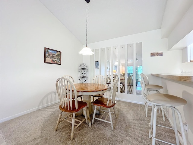 dining area with carpet, baseboards, and vaulted ceiling