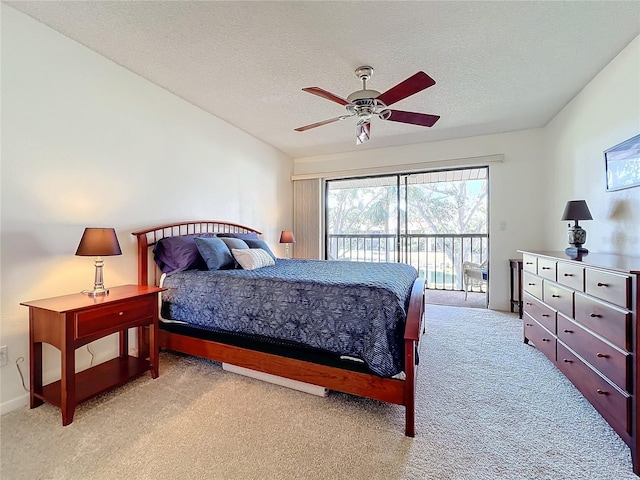 bedroom featuring light carpet, access to outside, a ceiling fan, and a textured ceiling