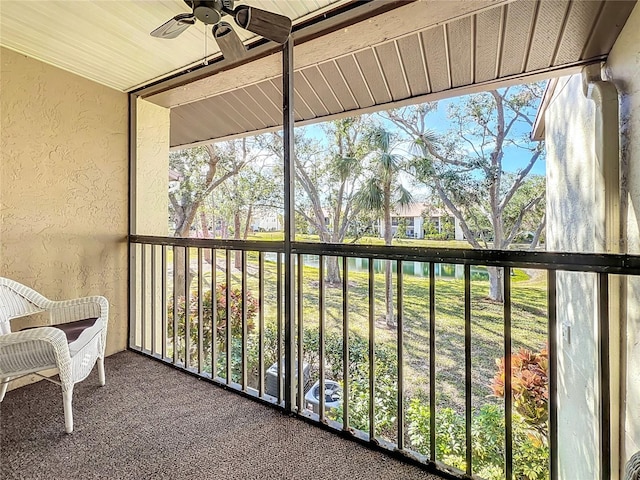 sunroom featuring ceiling fan and a wealth of natural light