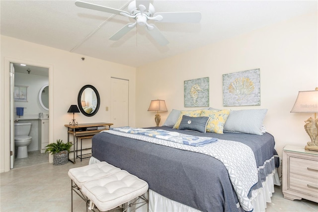 tiled bedroom with ceiling fan and ensuite bath