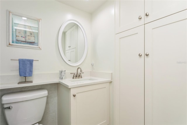 bathroom with toilet and vanity