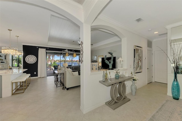 interior space with crown molding, light tile patterned flooring, sink, and a notable chandelier