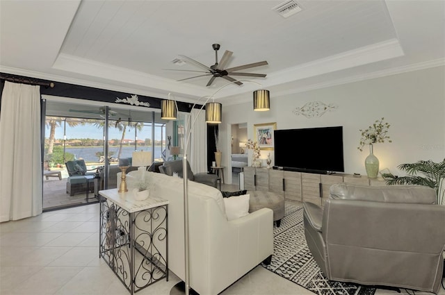 tiled living room with crown molding, a tray ceiling, and ceiling fan