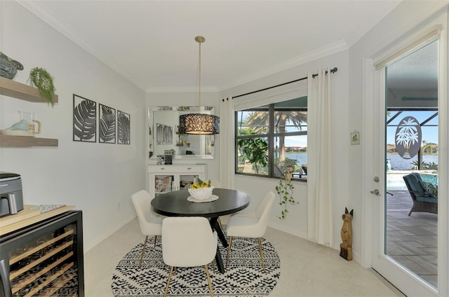 tiled dining area with wine cooler, a water view, and ornamental molding