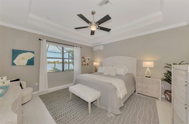 bedroom with crown molding, ceiling fan, a raised ceiling, and a wall unit AC