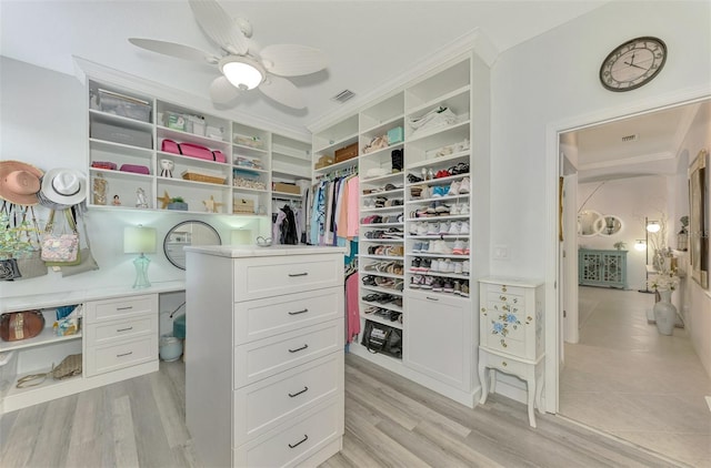 spacious closet featuring ceiling fan and light hardwood / wood-style floors