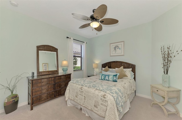 bedroom with ceiling fan and light carpet