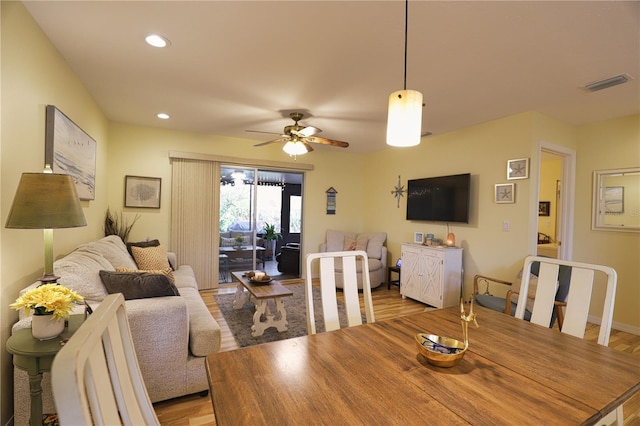 dining area featuring ceiling fan and light wood-type flooring