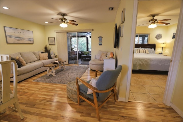 living room featuring ceiling fan and light wood-type flooring