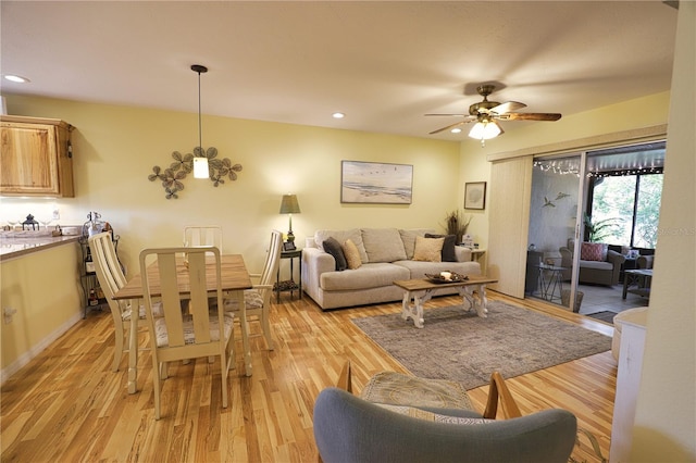 living room with ceiling fan and light hardwood / wood-style floors