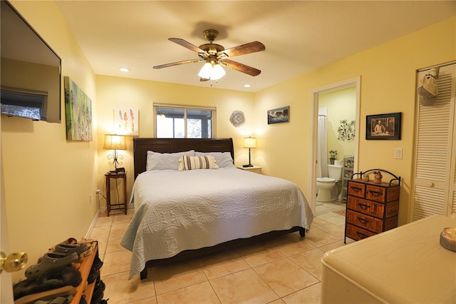 tiled bedroom featuring ceiling fan, a closet, and connected bathroom