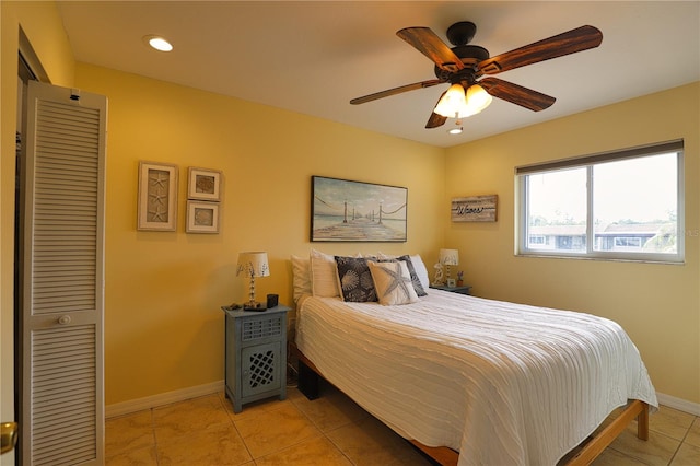 tiled bedroom featuring ceiling fan