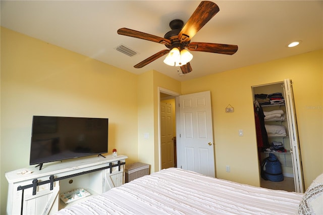 bedroom with a spacious closet, a closet, and ceiling fan