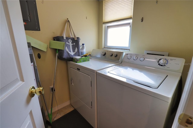 laundry area with washer and dryer, tile patterned flooring, and electric panel