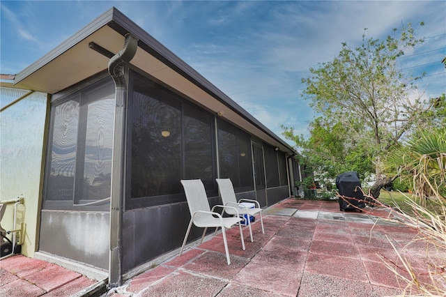 view of patio with a sunroom