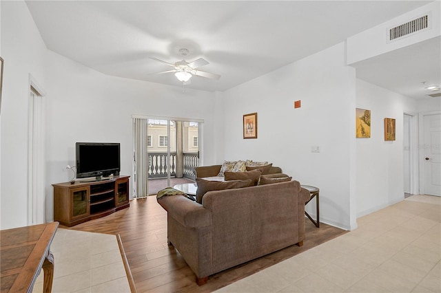 living room featuring ceiling fan and light hardwood / wood-style floors