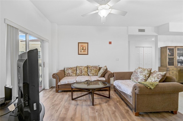 living room featuring ceiling fan and light hardwood / wood-style flooring