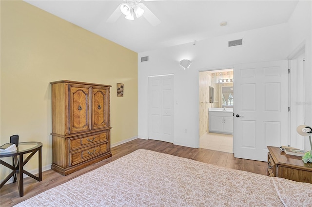 bedroom featuring light wood-type flooring, ceiling fan, a closet, and connected bathroom