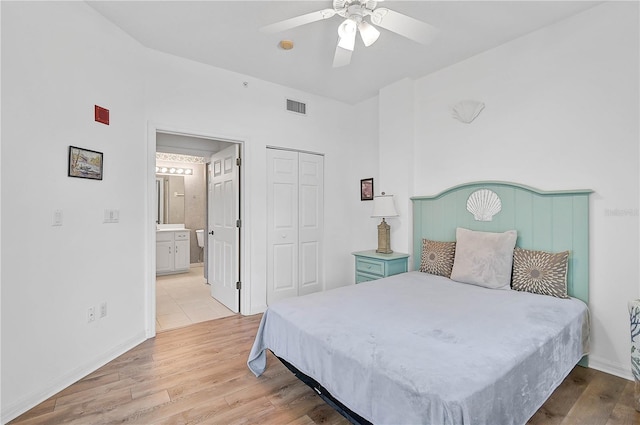 bedroom featuring ceiling fan, a closet, and light wood-type flooring