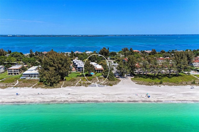 bird's eye view featuring a water view and a view of the beach