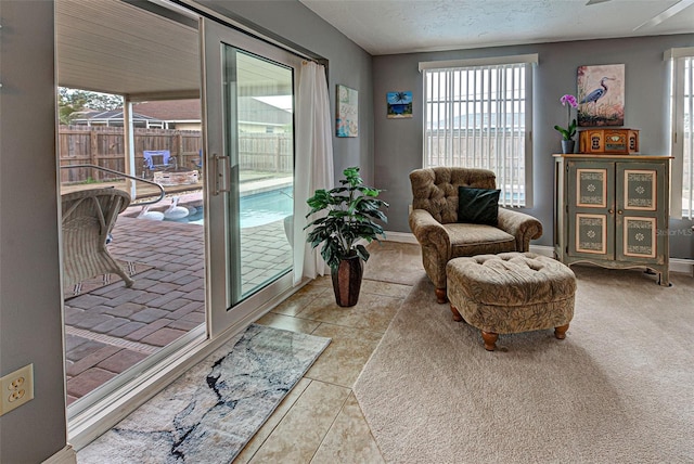 sitting room with a textured ceiling and light tile patterned flooring