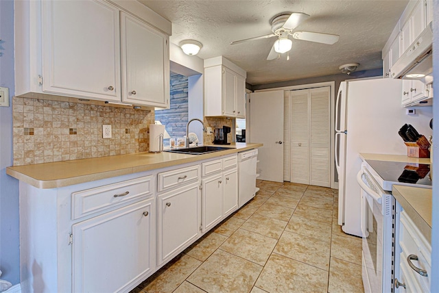 kitchen featuring white appliances, white cabinetry, sink, light tile patterned flooring, and ceiling fan