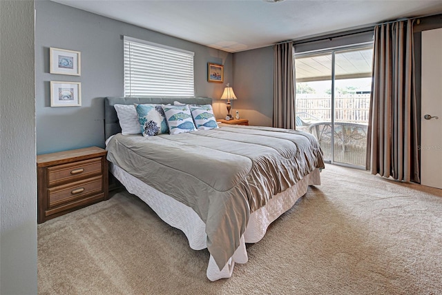 carpeted bedroom with access to outside and multiple windows