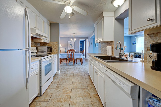 kitchen with decorative backsplash, sink, white appliances, and white cabinetry