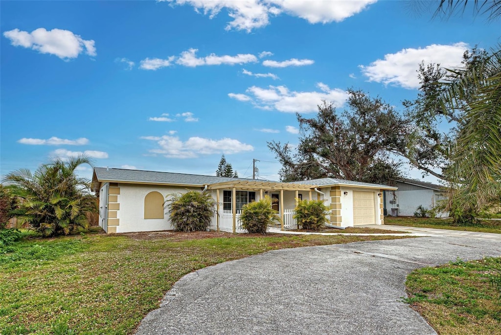 ranch-style house with a garage and a front yard