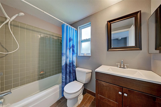 full bathroom featuring toilet, vanity, a textured ceiling, and shower / bathtub combination with curtain