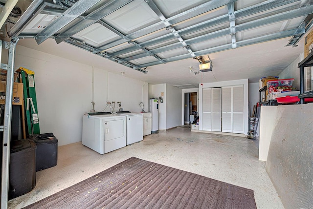 garage featuring electric water heater, washer and dryer, and a garage door opener