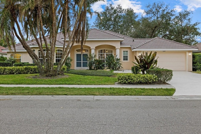 view of front of property with a front yard and a garage